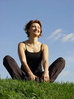 Picture of a contented woman sitting on grass.
