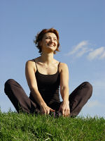 Picture of a contented woman sitting on grass. Picture of a contented woman sitting on grass.